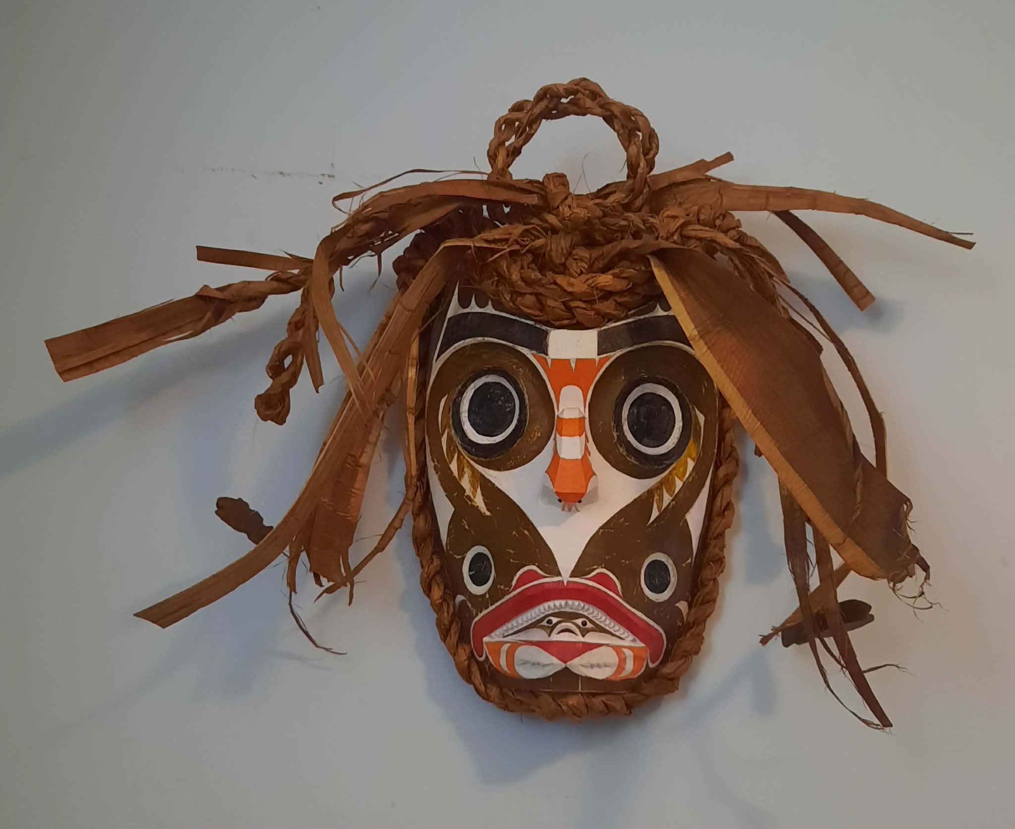 Carved mask with cedar bark fringe hair